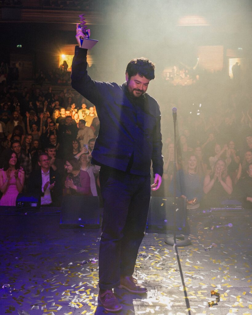 Dafydd Owain celebrating his Welsh Music Prize win
